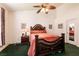 Spacious bedroom featuring a ceiling fan, large bed with decorative headboard, and neutral walls at 945 Stetson Dr, Henderson, NV 89002