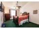Cozy bedroom with carpet, ceiling fan, and a large decorative bed at 945 Stetson Dr, Henderson, NV 89002