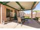 Inviting covered patio featuring ample seating, ceiling fan, and backyard access at 945 Stetson Dr, Henderson, NV 89002