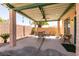 Outdoor patio seating area with ceiling fan and views of backyard at 945 Stetson Dr, Henderson, NV 89002