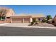 Attractive single-story home featuring a two-car garage and desert landscaping in front at 945 Stetson Dr, Henderson, NV 89002