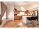 An open kitchen features an island, bar seating, stainless appliances and wooden cabinetry at 945 Stetson Dr, Henderson, NV 89002