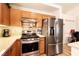 Bright kitchen featuring stainless steel appliances, light countertops, and wood cabinetry at 945 Stetson Dr, Henderson, NV 89002