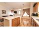 Beautiful kitchen island featuring wood cabinets and view into a seating area at 945 Stetson Dr, Henderson, NV 89002