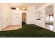 Spacious living room featuring green carpet, arched doorways, and multi-door entrance at 945 Stetson Dr, Henderson, NV 89002