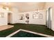 Open living room with arched doorways, carpet, and hanging light fixtures at 945 Stetson Dr, Henderson, NV 89002
