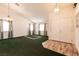 Inviting living room with green carpet, light fixtures, and a double-door entrance at 945 Stetson Dr, Henderson, NV 89002