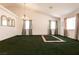 Spacious living room featuring green carpet and bright natural light at 945 Stetson Dr, Henderson, NV 89002