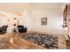 Open living room featuring hardwood floors, a comfortable chair, and a floral area rug at 945 Stetson Dr, Henderson, NV 89002