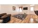 Bright living room with wood floors, a flat screen TV, and a cozy floral area rug at 945 Stetson Dr, Henderson, NV 89002