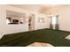 Living room with arched doorway, green carpet, and hanging light fixture at 945 Stetson Dr, Henderson, NV 89002