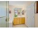 Bright bathroom featuring single sink vanity, a shower with glass door, and a soaking tub at 967 Cardelina Ln, Henderson, NV 89052