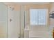Ensuite bathroom featuring a tub and shower combination with a glass enclosure at 967 Cardelina Ln, Henderson, NV 89052