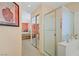 Ensuite bathroom featuring double mirrors and sinks, and a shower with a glass door at 967 Cardelina Ln, Henderson, NV 89052