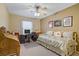 Comfortable bedroom with ceiling fan, large window, study desk, and closet at 967 Cardelina Ln, Henderson, NV 89052