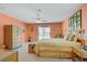 Bright main bedroom boasts a ceiling fan, private access to a patio, and an ensuite bath at 967 Cardelina Ln, Henderson, NV 89052