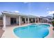 Relaxing backyard pool with a covered patio and greenhouse, perfect for enjoying the outdoors at 967 Cardelina Ln, Henderson, NV 89052
