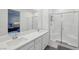 Modern bathroom with dual sinks, white cabinetry, and a glass-enclosed walk-in shower at 9714 Harper Edge St, Las Vegas, NV 89143