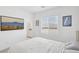 Bright bedroom featuring neutral walls, a large window with mountain views, and decorative wall art at 9714 Harper Edge St, Las Vegas, NV 89143