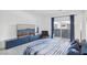 Bright bedroom featuring modern bed frame, plush carpet, and a sliding glass door at 9714 Harper Edge St, Las Vegas, NV 89143