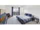 Bright bedroom featuring modern bed frame, plush carpet, and a sliding glass door at 9714 Harper Edge St, Las Vegas, NV 89143