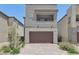 Stylish two-story home boasts a stone-accented facade and a neatly paved driveway at 9714 Harper Edge St, Las Vegas, NV 89143