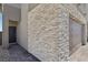 Modern home exterior with stone accents, gray door, and paved walkway at 9714 Harper Edge St, Las Vegas, NV 89143