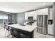 Bright kitchen features stainless steel appliances, a center island, and white cabinetry at 9714 Harper Edge St, Las Vegas, NV 89143