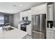 Modern kitchen featuring white cabinets, stainless steel appliances, and a quartz countertop at 9714 Harper Edge St, Las Vegas, NV 89143