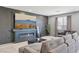 Modern living room with sleek fireplace, large TV, and comfortable gray sectional sofa at 9714 Harper Edge St, Las Vegas, NV 89143