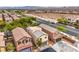 Aerial view of rooftops in a neighborhood with desert landscaping, and nearby roads at 10085 S Riley St, Las Vegas, NV 89178