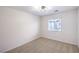 Bright bedroom featuring neutral carpeting, white walls, and a window at 10085 S Riley St, Las Vegas, NV 89178
