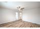 Bedroom with wood-look floors, ceiling fan, and walk-in closets at 10085 S Riley St, Las Vegas, NV 89178