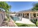 Backyard view showcasing the fenced pool, desert landscaping, and solar panels on the roof at 10113 Plomosa Pl, Las Vegas, NV 89134