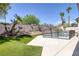 Well-maintained backyard featuring a fenced pool, desert landscaping, and artificial turf at 10113 Plomosa Pl, Las Vegas, NV 89134