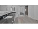 Bright bathroom featuring dual sinks, hardwood floors and a glass shower at 10113 Plomosa Pl, Las Vegas, NV 89134