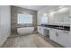 Elegant bathroom featuring modern fixtures, a soaking tub, and light wood floors at 10113 Plomosa Pl, Las Vegas, NV 89134