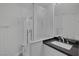 Modern bathroom features a glass shower and sleek black countertop with a rectangular sink at 10113 Plomosa Pl, Las Vegas, NV 89134