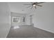 Spacious bedroom with a ceiling fan, carpet and a view to the backyard at 10113 Plomosa Pl, Las Vegas, NV 89134