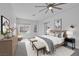 Bright bedroom with white walls, ceiling fan, stylish furniture, and neutral accents for a relaxing atmosphere at 10113 Plomosa Pl, Las Vegas, NV 89134