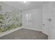 Stylish bedroom featuring a painted accent wall with botanical pattern and white trim at 10113 Plomosa Pl, Las Vegas, NV 89134