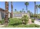 Entrance to Highpointe community showcasing lush desert landscaping and mature palm trees at 10113 Plomosa Pl, Las Vegas, NV 89134