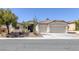 Charming single-story home featuring a desert landscape, tile roof, and a two-car garage at 10113 Plomosa Pl, Las Vegas, NV 89134