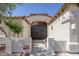 Welcoming courtyard entry to this home with stucco walls, arched openings, and an iron gate at 10113 Plomosa Pl, Las Vegas, NV 89134