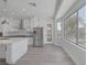Bright kitchen featuring stainless steel appliances, an island, white cabinets, and ample sunlight at 10113 Plomosa Pl, Las Vegas, NV 89134