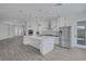 Open kitchen featuring a large center island, white cabinetry, and stainless steel appliances at 10113 Plomosa Pl, Las Vegas, NV 89134