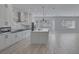 Bright, open kitchen featuring white cabinetry, stainless steel appliances, and a large center island at 10113 Plomosa Pl, Las Vegas, NV 89134
