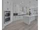 Well-lit kitchen showcasing white cabinets, a marble backsplash, and stainless steel appliances at 10113 Plomosa Pl, Las Vegas, NV 89134