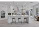 Bright kitchen with white cabinets, a large island, stainless steel appliances, and stool seating at 10113 Plomosa Pl, Las Vegas, NV 89134
