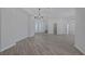 Expansive open-concept living area with wood-look floors, modern lighting, and a view of the entry at 10113 Plomosa Pl, Las Vegas, NV 89134